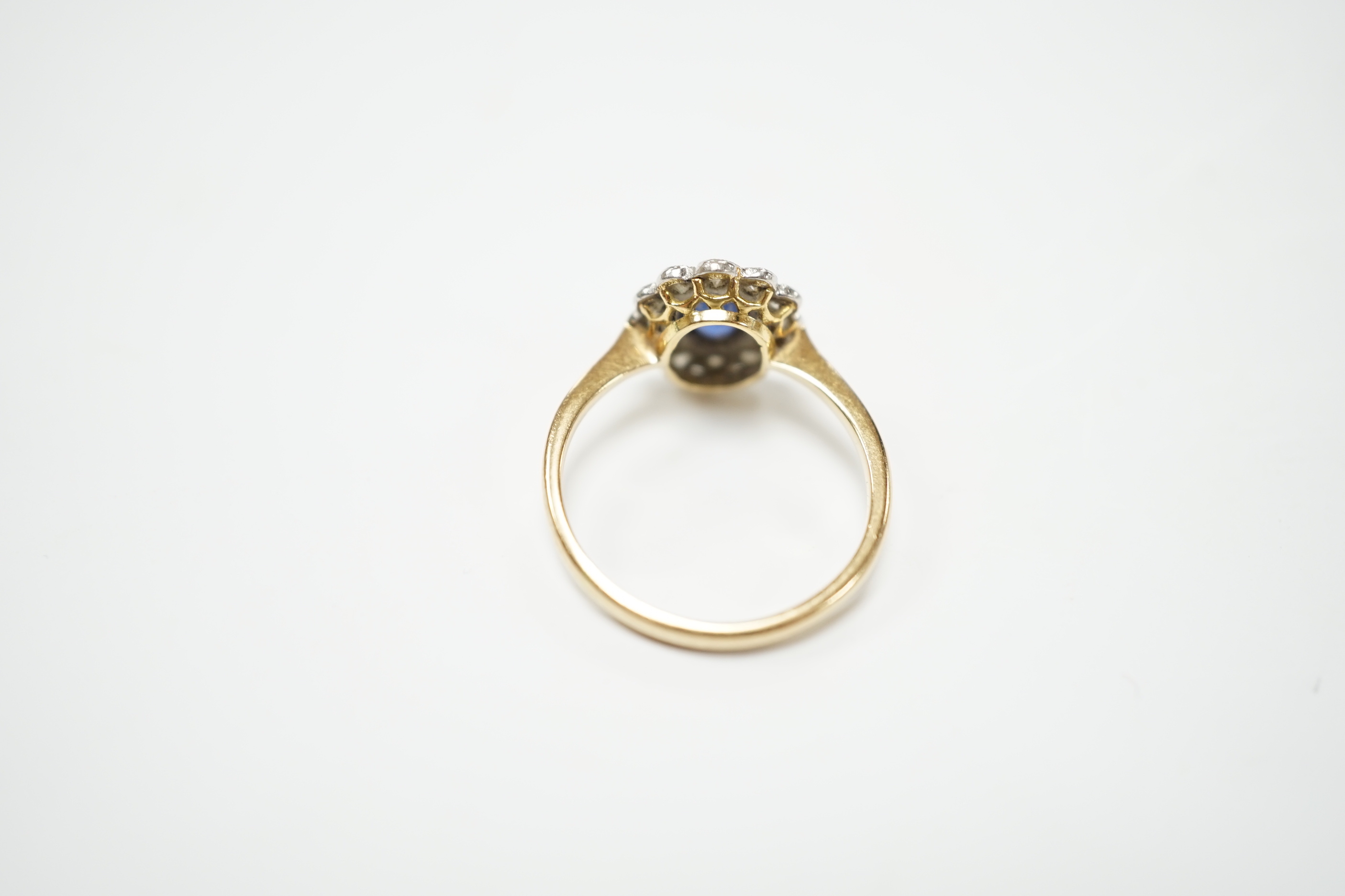 An early to mid 20th century 18ct and plat. sapphire and diamond set oval cluster ring, size L, gross weight 2.5 grams.